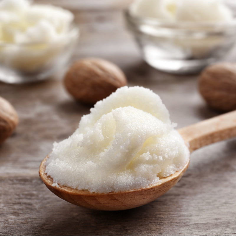 Image of a spoonful of shea butter, a natural ingredient used in Bioluminescence Argan Eye Balm for its hydrating and nourishing properties.