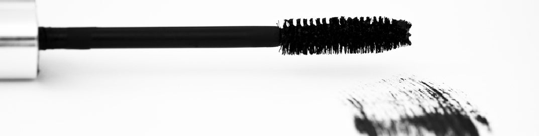 Mascara wand on white background representing how to apply mascara