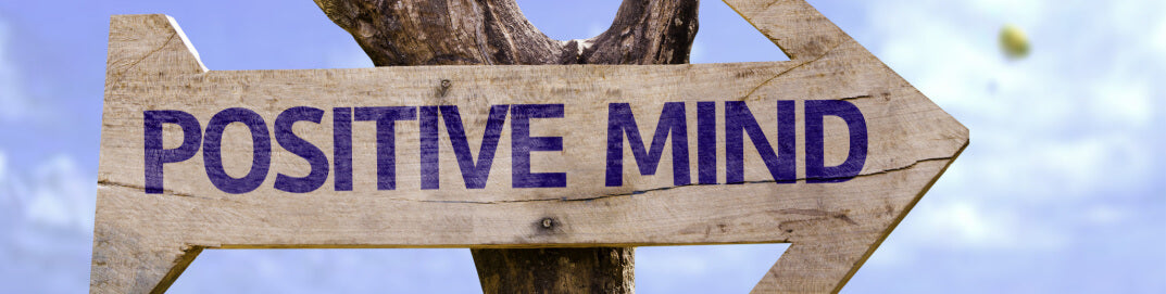 A signpost indicating the words positive mind representing what is a mindful person