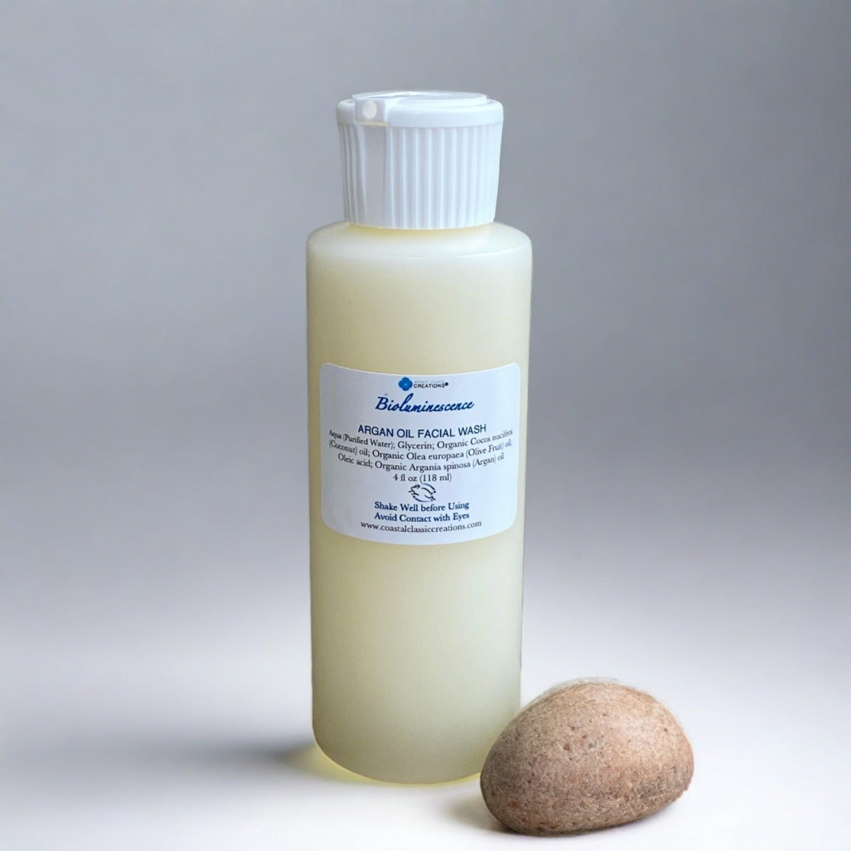 Bioluminescence Argan Facial Wash: A 4 oz bottle with a white flip cap containing a fragrance-free, plant-based cleanser. The label showcases its natural ingredients, promising a gentle yet effective cleansing experience