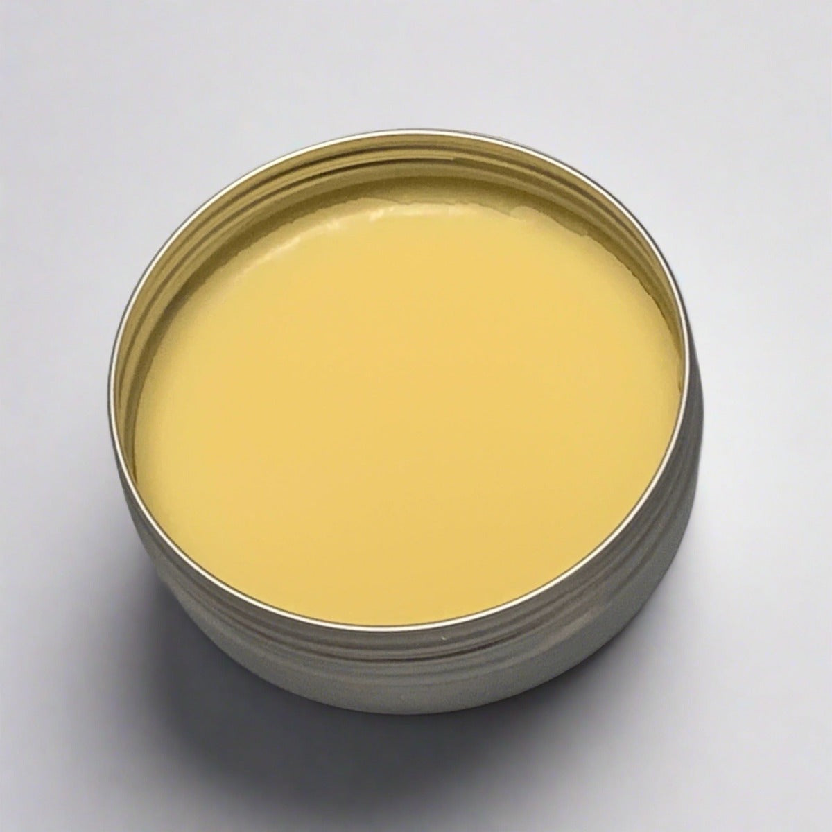 An image of a jar of Safe Harbor Hair Pomade, showcasing its sleek design and minimalist appearance. The pomade, enriched with pure botanicals, promises healthier and more vibrant hair. With options for various scents or an unscented choice, it offers a personalized experience for users seeking a premium hair care solution.