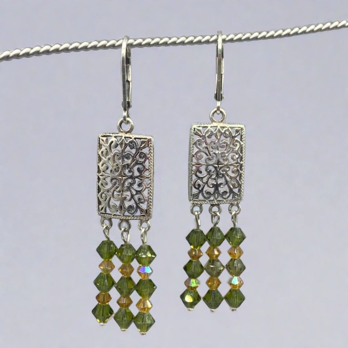 A pair of exquisite Aquatic Flowers Olivine Crystal Chandelier Earrings, featuring shimmering crystals 