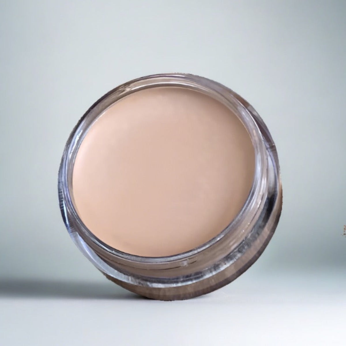Cosmetic jar of Blemish and Capillary Cream Concealer: Close-up view highlighting the creamy texture and rich pigment of the product
