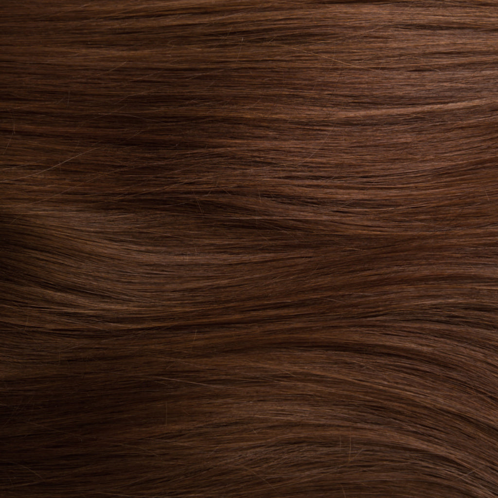 Swatch of brown henna-colored hair showing rich golden tones 