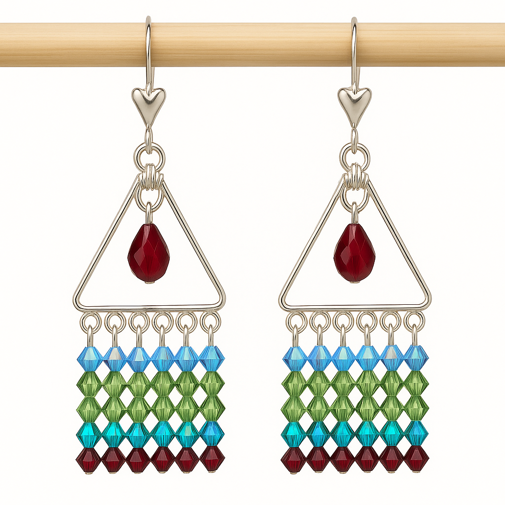 Sterling silver crystal drop earrings hanging from a  wooden dowel on a white background