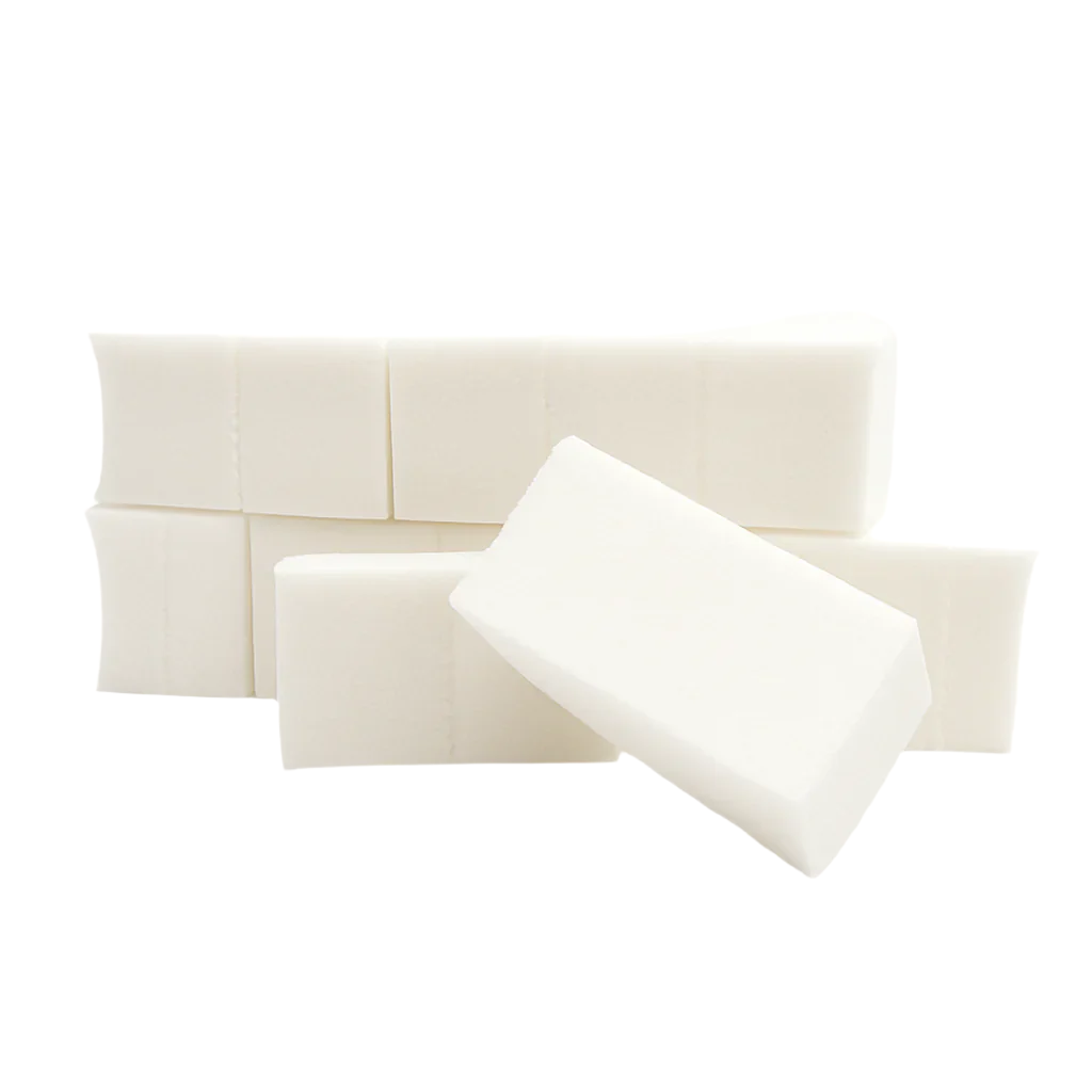 Set of latex-free cosmetic wedges in soft white, stacked and angled, shown on a clean white background