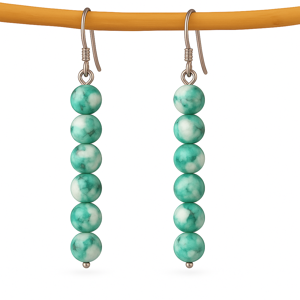 Pair of green and white agate beaded earrings on a white background