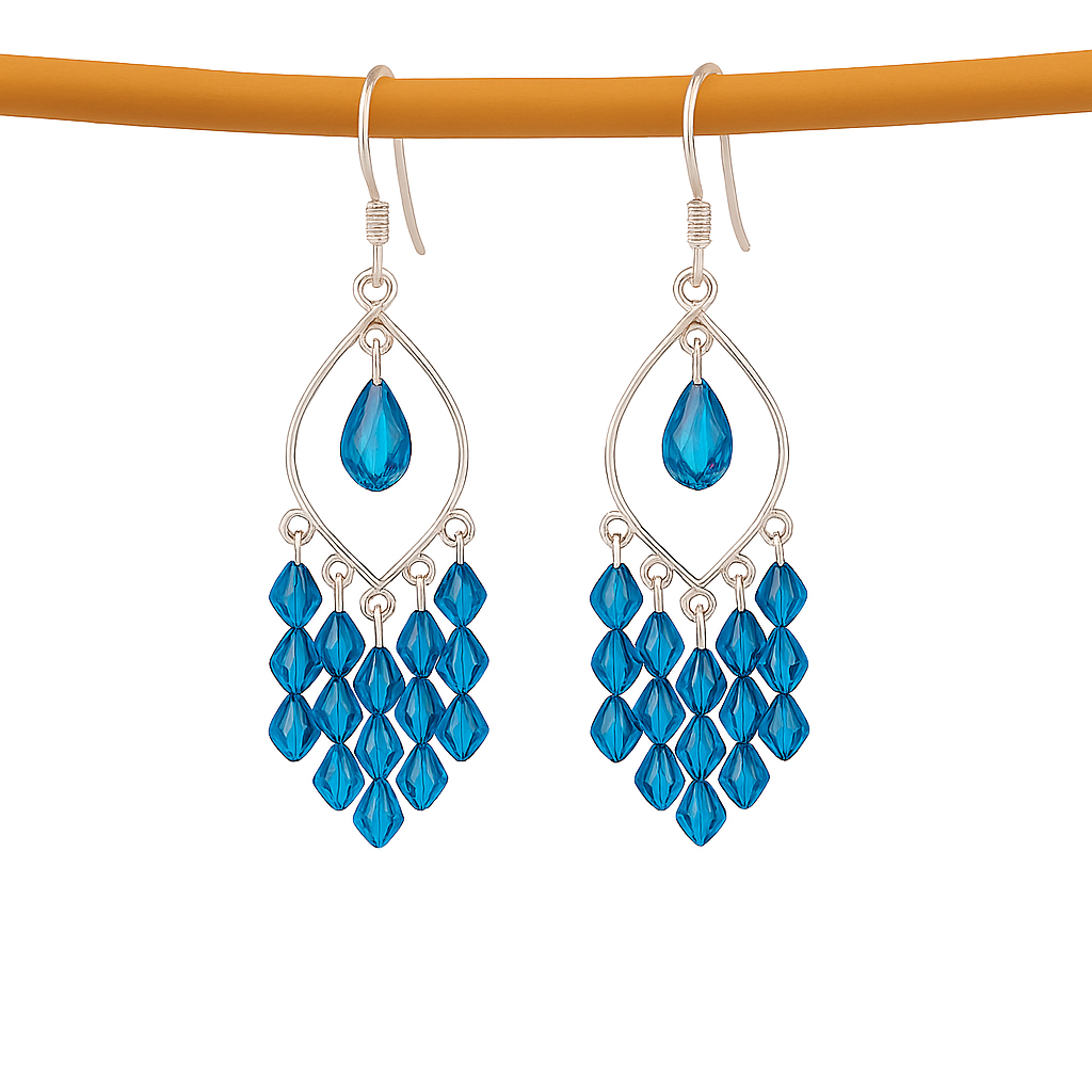 Blue teardrop earrings with silver hooks on a white background