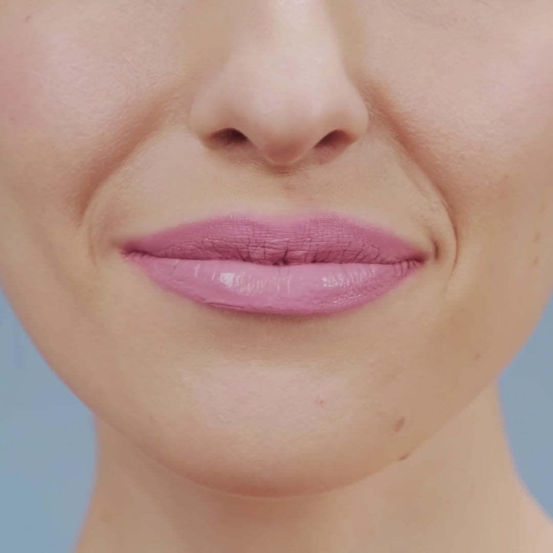 Partial view of a woman’s face wearing luminous pink lipstick, showcasing the vibrant tone of Pink Princess Lipstick.