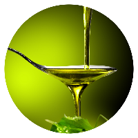 Olive oil being dripped into a spoon over lettuce