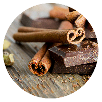 Chocolate bar and spices on wooden table