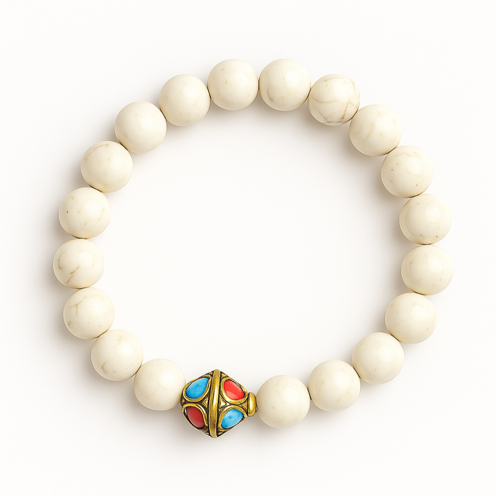 Stretch bracelet with 8mm white magnesite beads and a gold-toned accent bead with red and turquoise enamel, shown on white background