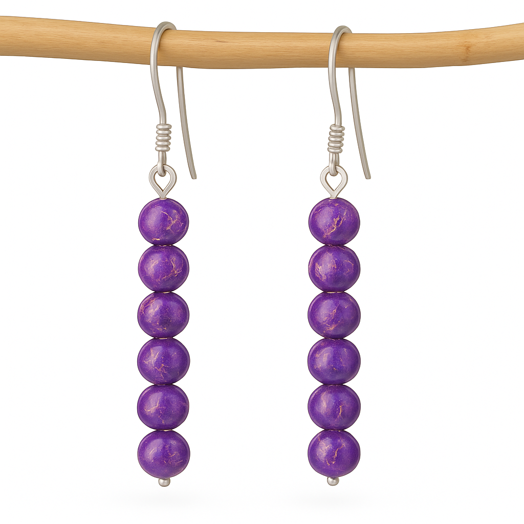 Dangle earrings with six round purple marbled impression stone beads on silver hooks, shown on a smooth wooden dowel