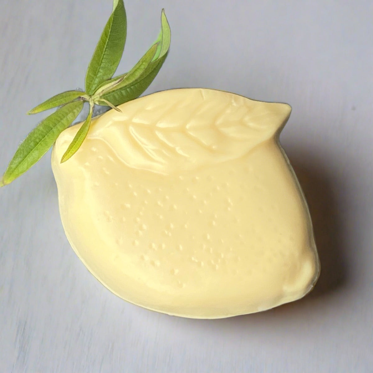Lemon shaped bar of  lemon-scented antibacterial soap 