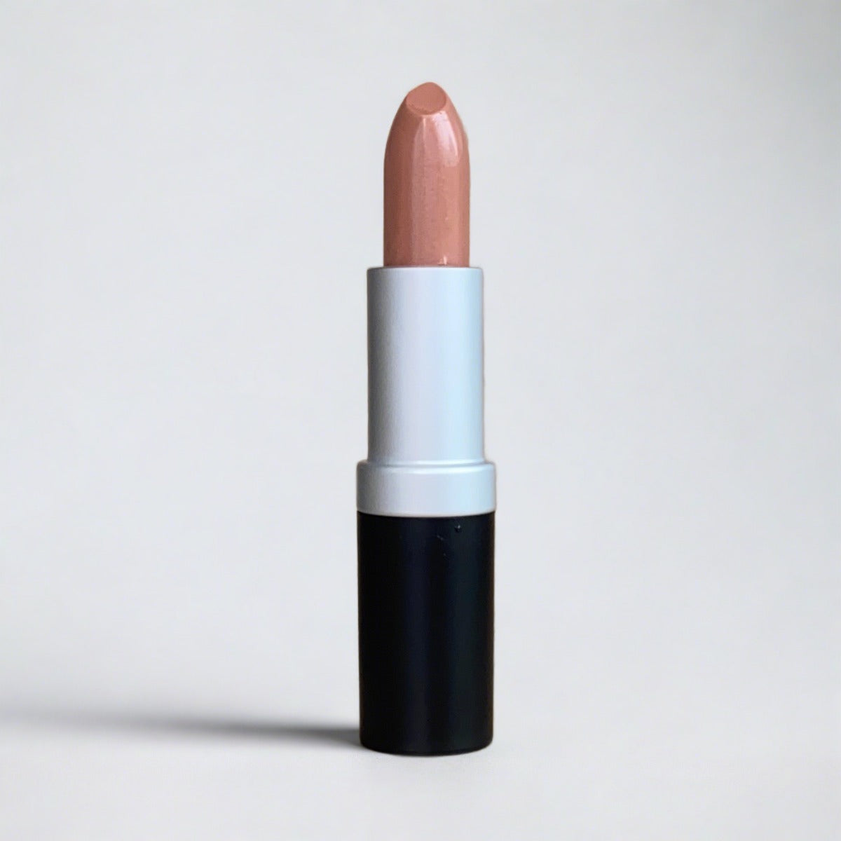 Nude pink lipstick on rock background