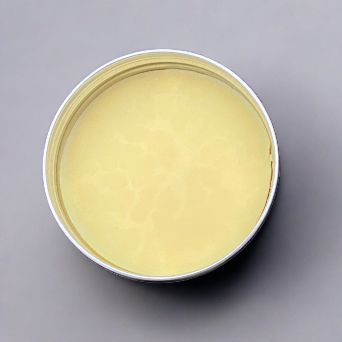 Multi-action organic orange butter face cream on rock background